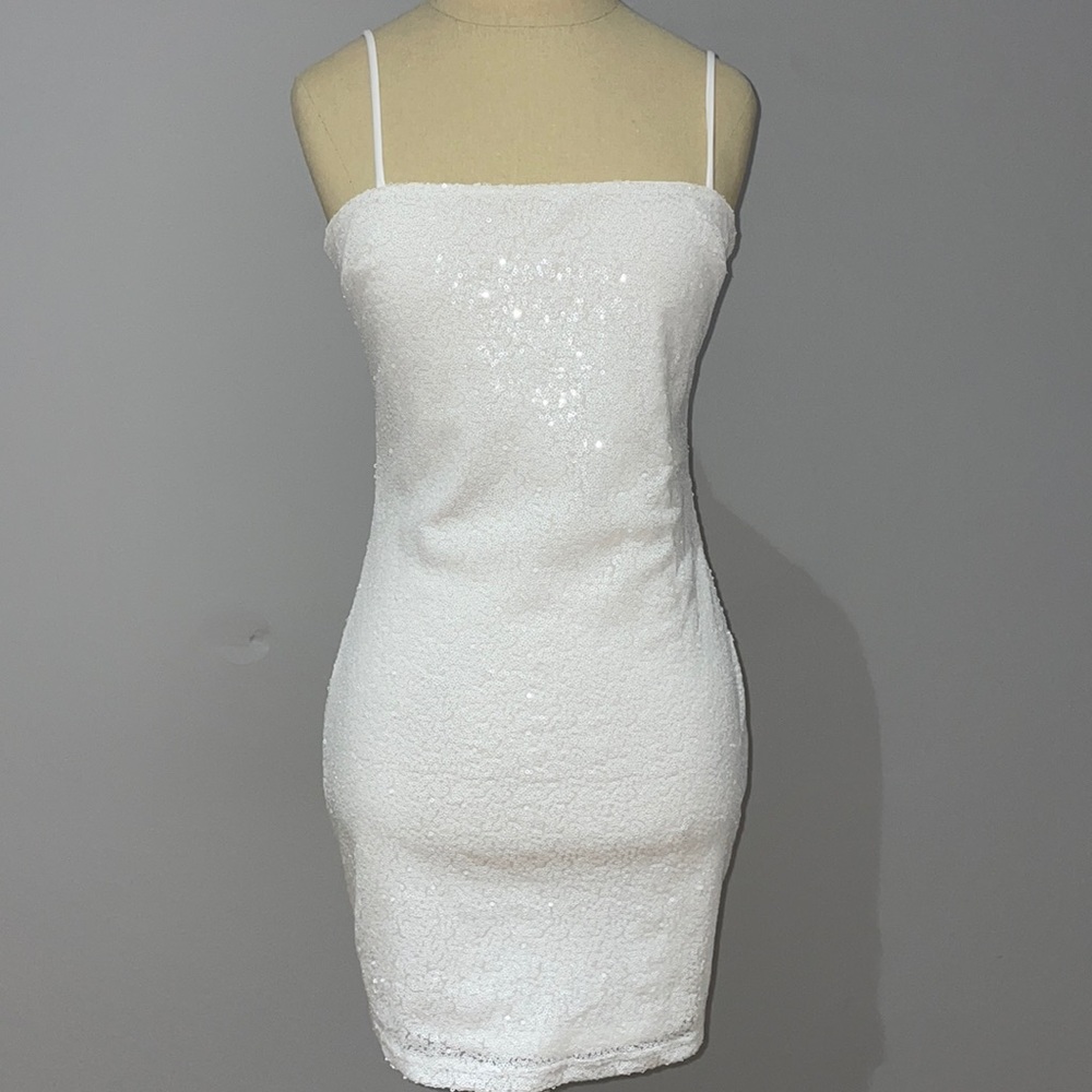 White sequin mini dress with open back and bow
